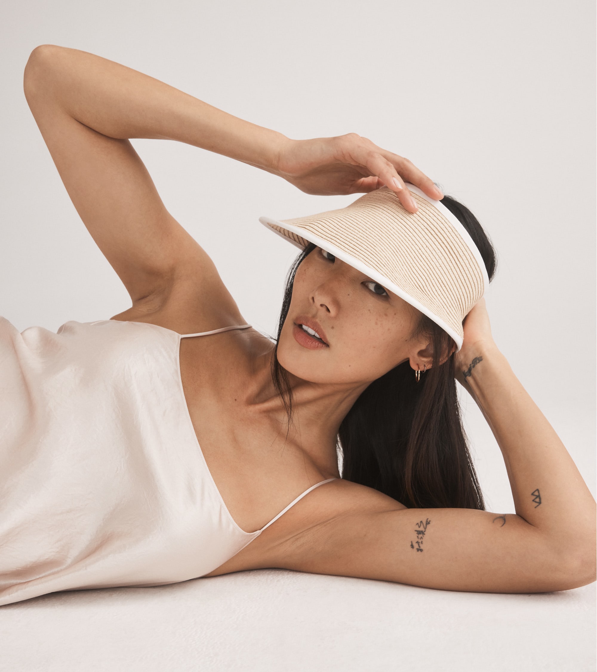 Female model wearing a straw visor